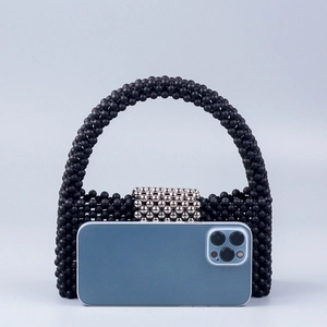 Chic black beaded handbag with silver accents and integrated handle for evening wear