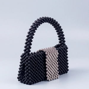 Handmade black beaded tote bag with silver sphere buckle and elegant curved handle