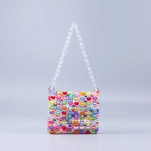 Detail of colorful acrylic heart-beaded mini bag with transparent resin chain strap