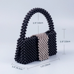 Detailed view of handmade black beaded evening bag showing dimensions and texture