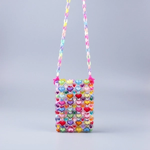 Detail of colorful acrylic heart beads and woven texture on a stylish crossbody phone bag