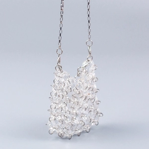 Close-up of clear acrylic crystal beaded mini bag with silver box chain and faceted beads