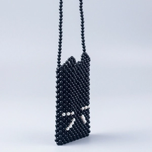 Handmade black beaded crossbody bag featuring a white cat face design with shoulder strap