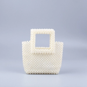 Macro shot of handcrafted faux pearl weave pattern and lustrous beaded bag surface