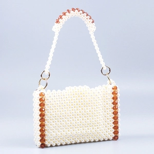 Detail of handmade beaded tote with ivory faux pearls and brown faceted crystal accents