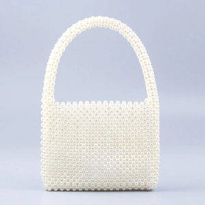 Detailed view of handmade square pearl bead handbag with elegant woven top handle