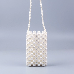 Detailed view of woven pearl pattern and texture on a white mini crossbody phone bag