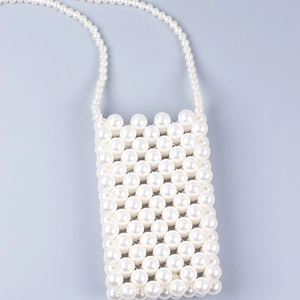 Detailed close-up of handmade white pearl crossbody mini bag with woven bead texture
