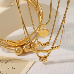 Minimalist 18k gold plated heart and bead layered necklace set with a polished finish