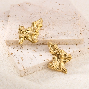 Artistic vintage gold North Star earrings with twisted lava texture and mirror finish
