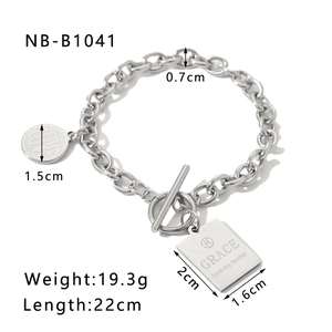 Detail of silver stainless steel T-bar bracelet with heart and tag charms with dimensions