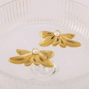 Elegant 18k gold plated wing earrings with centered pearls on a textured glass tray