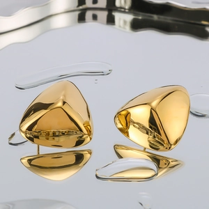 Polished 18k gold plated stainless steel triangle stud earrings on mirror background