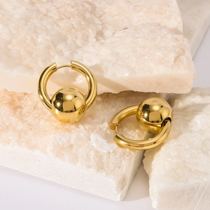 Minimalist 18K gold plated stainless steel round bead earrings on a white stone background