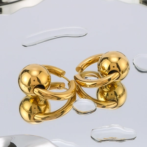 Modern 18k gold plated stainless steel sphere drop earrings on reflective water surface