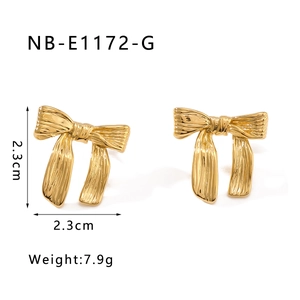 Détail des boucles d'oreilles nœud dorées avec texture brossée, 2,3cm et poids 7,9g
