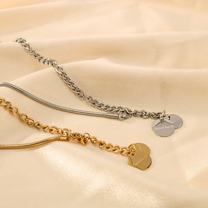 Detail of 18k gold and silver mixed link chains with Good Luck engraved charms
