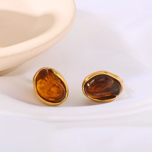 Retro circular resin earrings with 18K gold-plated stainless steel edges on white fabric