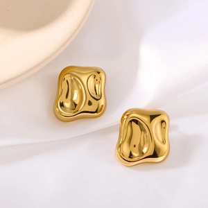 Polished gold irregular geometric earrings on white silk with minimalist design