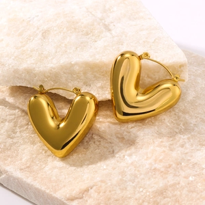 Polished hollow heart earrings in 18K gold plated stainless steel on stone