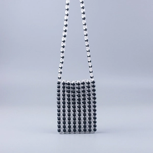 Detailed close-up of handmade acrylic beaded crossbody phone bag with striped texture