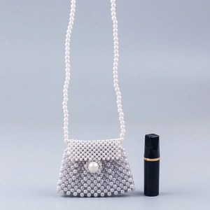 Handmade pearl woven mini crossbody bag with trapezoid flap and long beaded strap