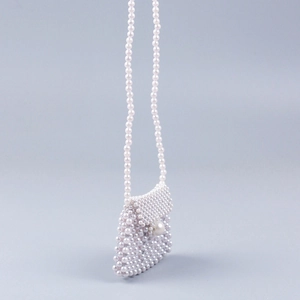 Handmade pearl woven crossbody bag with elegant flap and delicate beaded shoulder strap