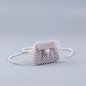 Handmade woven pearl crossbody bag with large pearl clasp and long strap in white