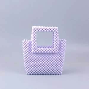 Macro shot of handcrafted lavender acrylic bead weave on this stylish evening bag