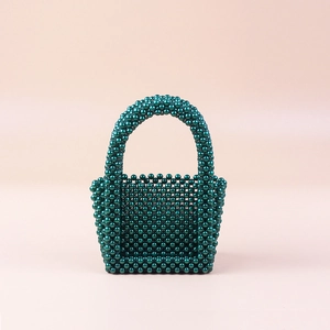 Detailed close-up of the dark green handmade pearl beaded mini handbag with glossy finish
