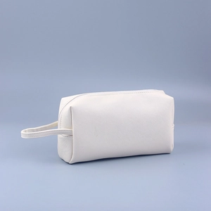 Detail of white Saffiano leather mini clutch showing fine texture and side strap