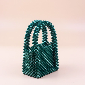 Handmade emerald green pearl beaded handbag with dual handles for elegant evening gala events