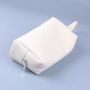 Detailed macro view of white Saffiano PU leather pouch with silver zipper and handle