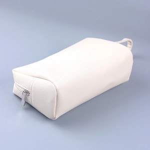 Detailed view of the white PU leather cross-pattern texture and silver metal zipper