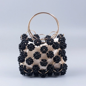 Handmade black beaded handbag with gold metal rings and beige satin lining for elegant parties