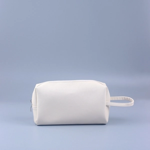 Detail of white cross-textured PU leather mini clutch bag with side strap and metal zipper