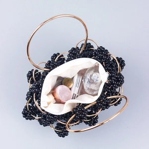Handcrafted black beaded handbag with gold metal rings and spacious white inner lining