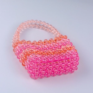 Handmade beaded mini bucket bag featuring pink and orange gradient acrylic crystals
