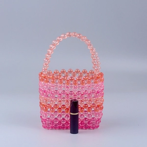 Mini pink and orange gradient acrylic beaded bucket bag with lipstick for size scale