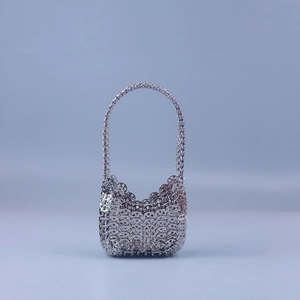 Detail shot of silver sequin metal link chain handbag with intricate craft texture