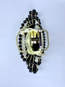 Detailed top view of handmade beaded evening bag with pearls, metal frame, and satin liner