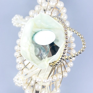 Handcrafted pearl beaded fan-shaped evening clutch with gold metal frame and silk lining