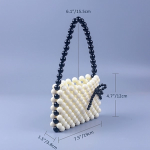 Detailed view of handmade beaded tote bag with dimensions in cream and black acrylic