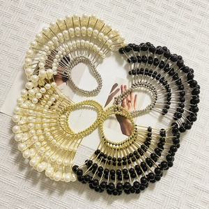 Detailed macro view of fan-shaped pearl hair clips with gold and silver beadwork
