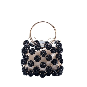 Handmade beaded ball-shaped evening bag with gold metal handle and floral black beads