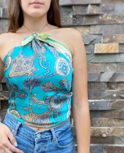 Detail of turquoise paisley satin scarf worn as a halter top with light green neck ties