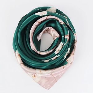 Macro detail of dark green satin scarf with floral cherry blossom print patterns