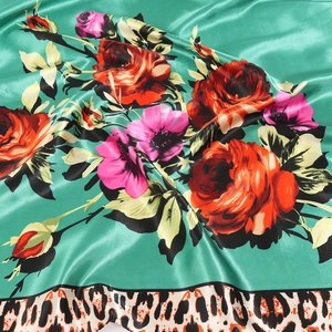 Green silk satin scarf featuring red roses and leopard print border with elegant sheen