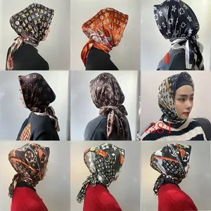 Detail grid of 9x9cm satin square scarves with chain print and letter motifs