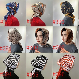 Detail showing nine assorted 90cm satin silk scarves with elegant floral and geometric patterns
